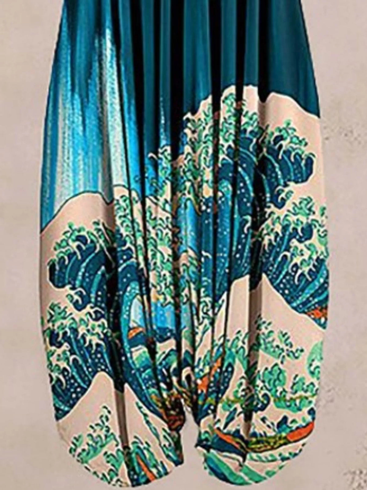 Teal wave-print V-neck sleeveless jumpsuit, leg and print detail