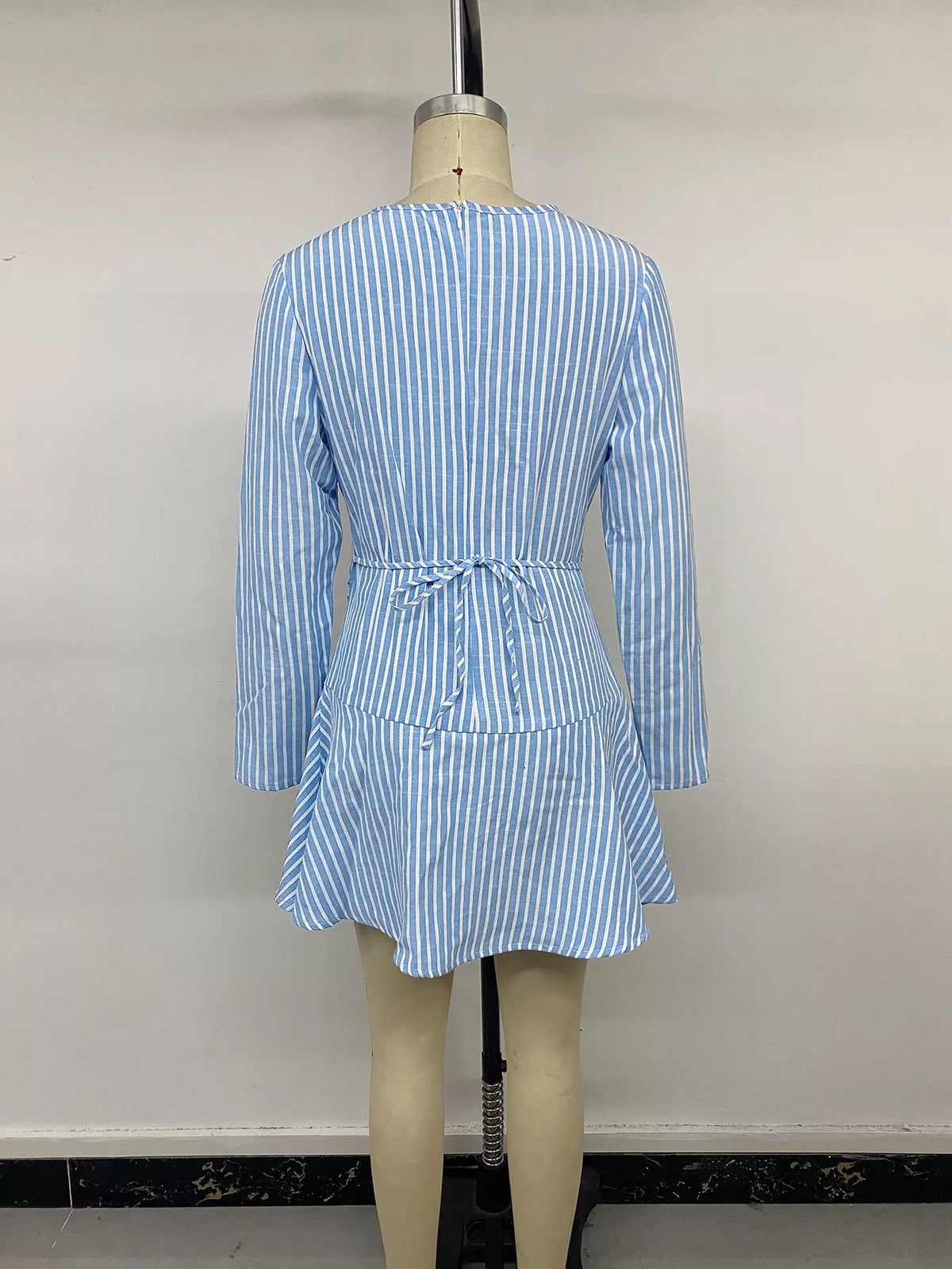 Blue striped long sleeve mini dress, back on mannequin
