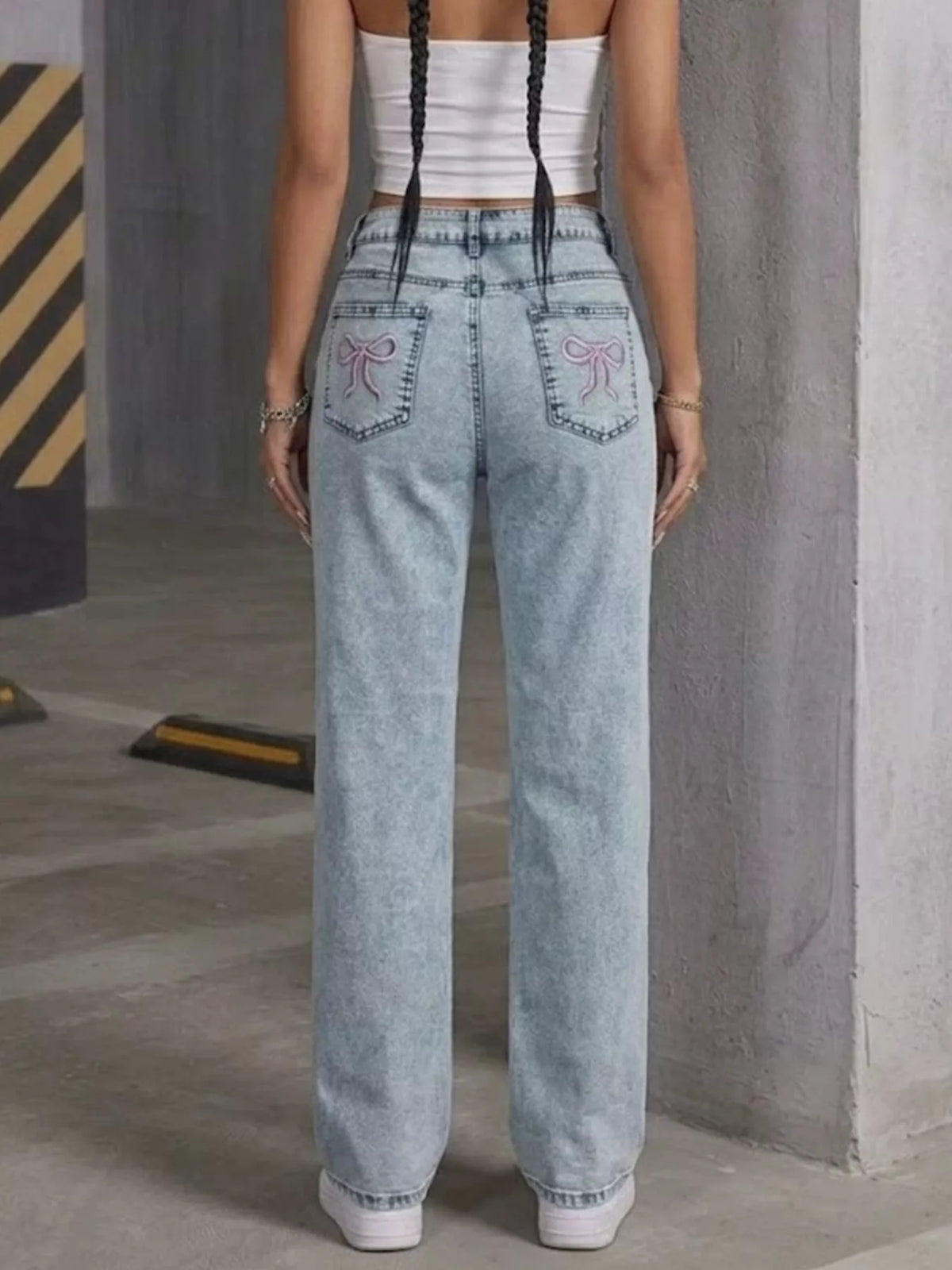 Light blue high-waisted acid-wash straight-leg jeans, back view.