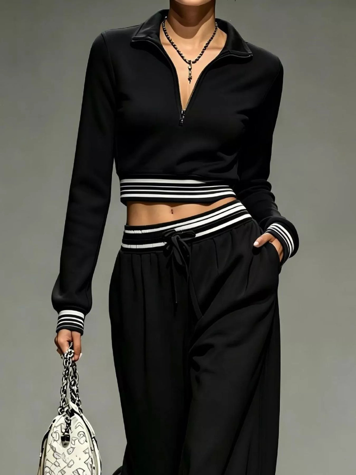 Black half-zip crop top and pants set, zip neckline and waist detail