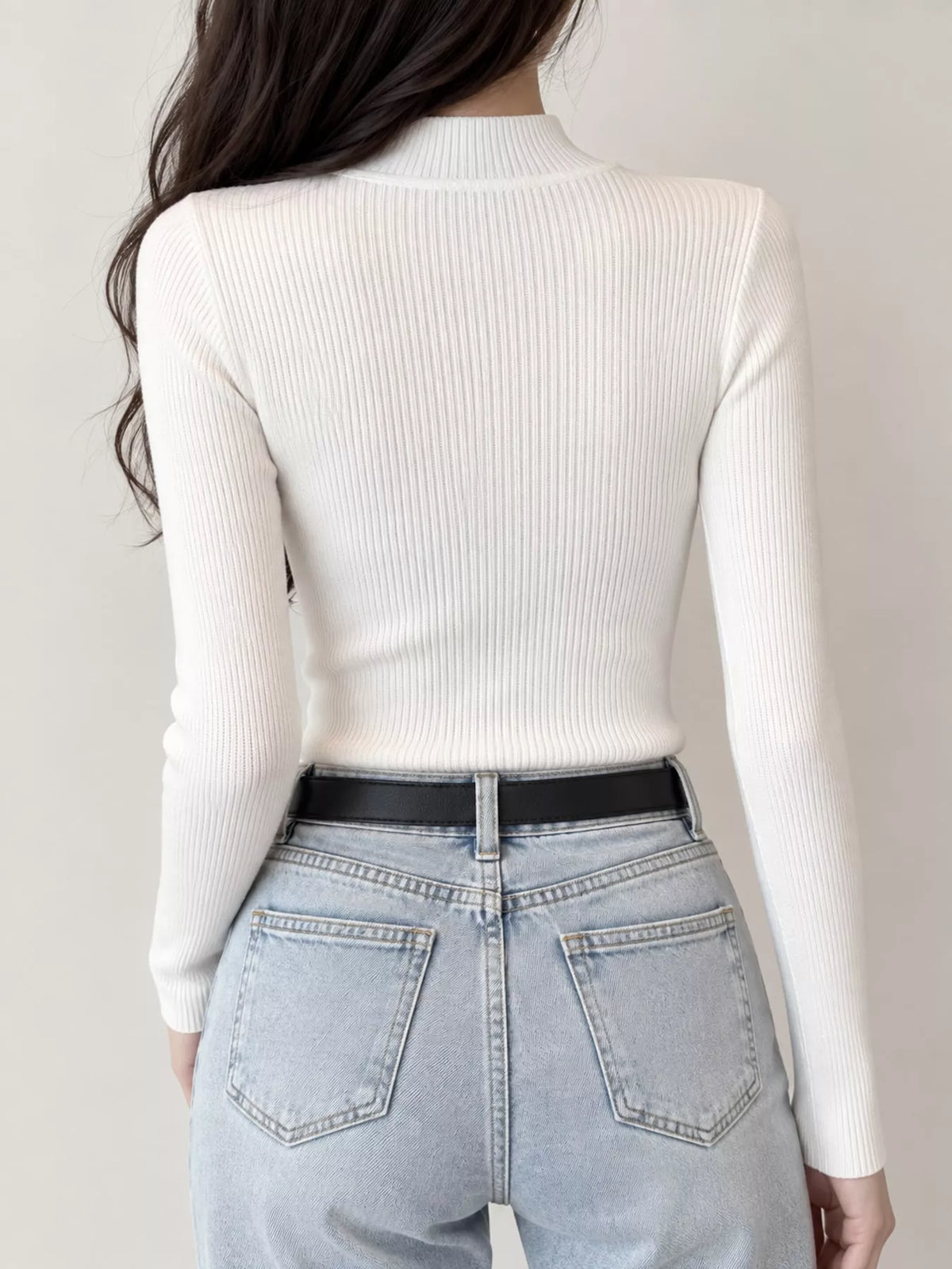 White ribbed mock neck long sleeve knit top, back view