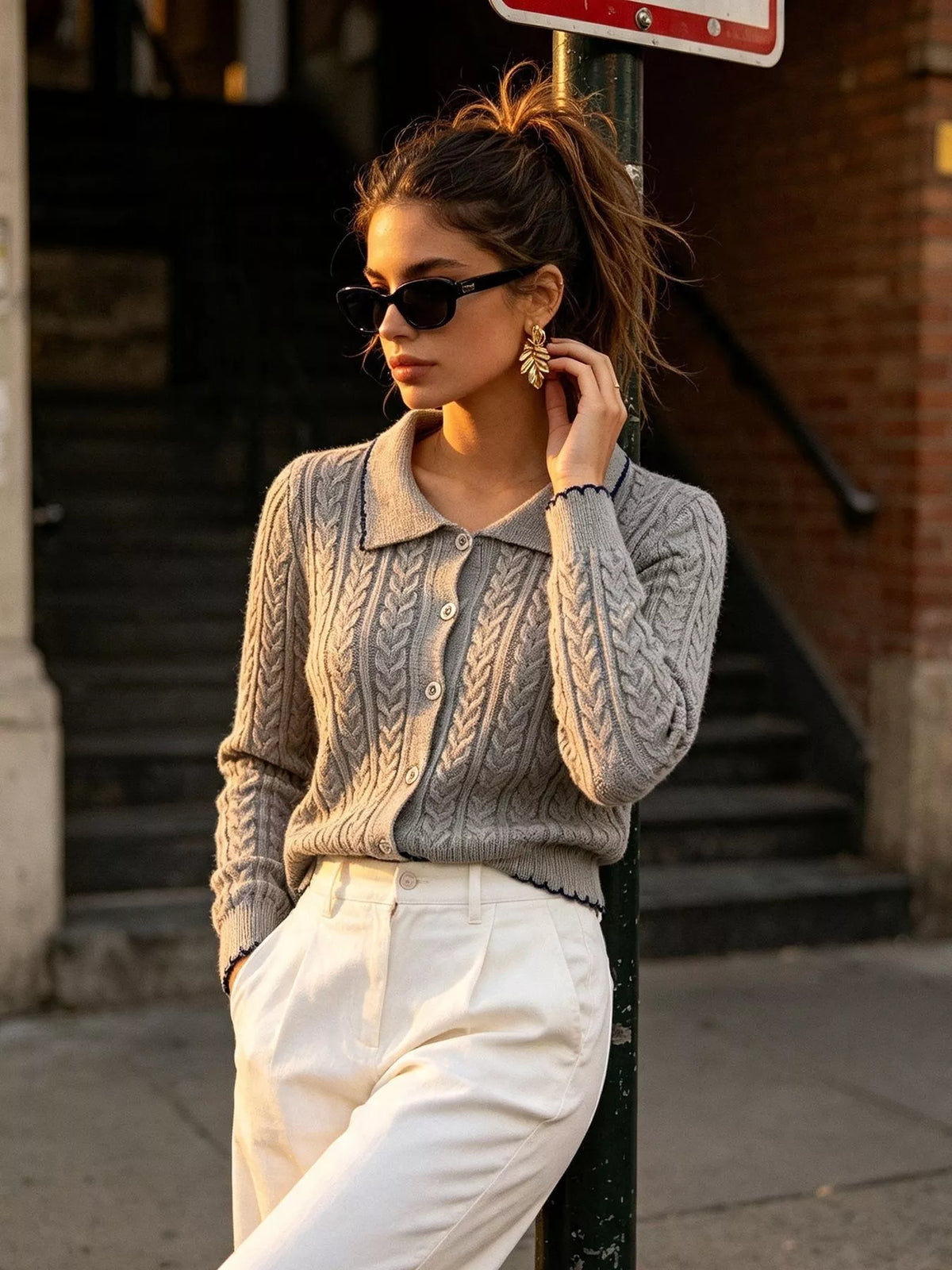 Gray cable-knit polo-collar cardigan, angled front view.