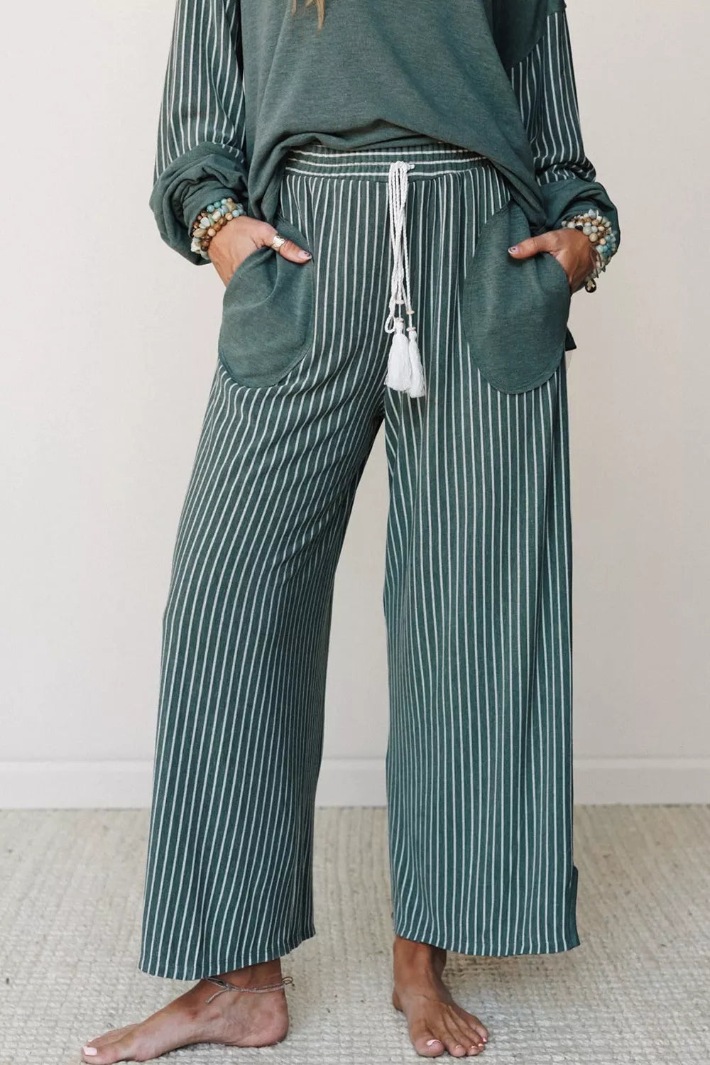 Green raw-seam top and striped pants set, front of pants