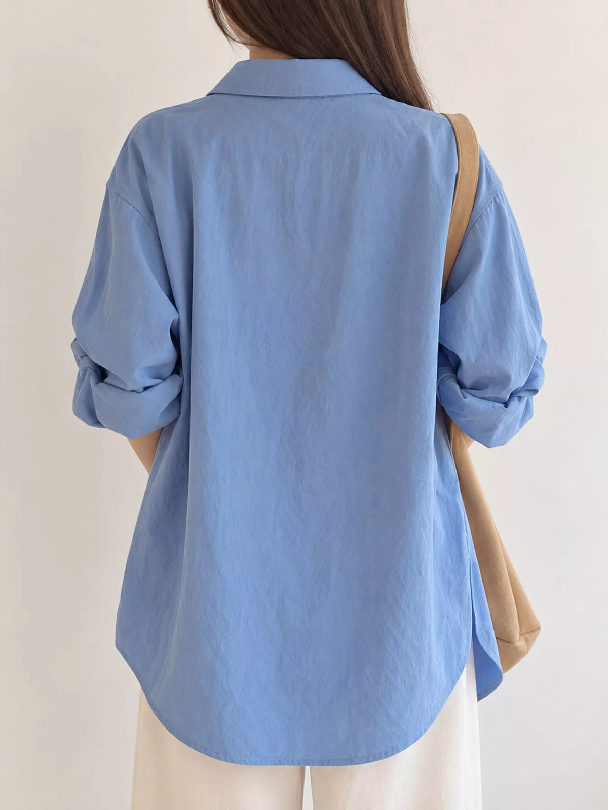 Blue button down long sleeve shirt, back view