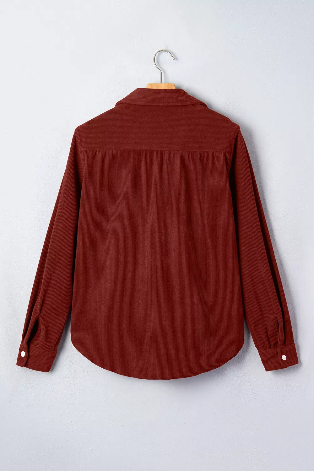 Rust corduroy button-down shirt, back on hanger