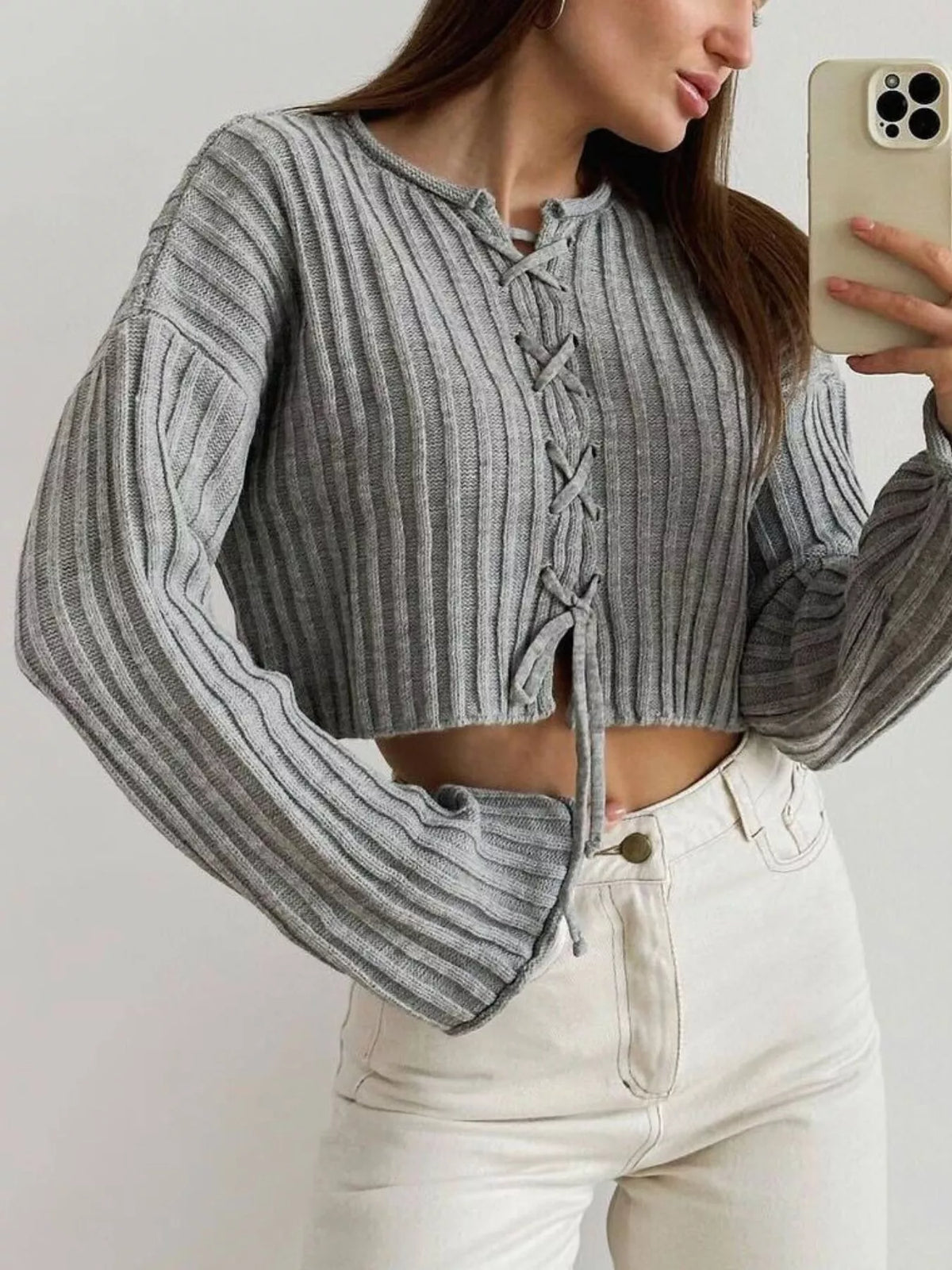 Gray ribbed lace-up cropped sweater, angled front view.