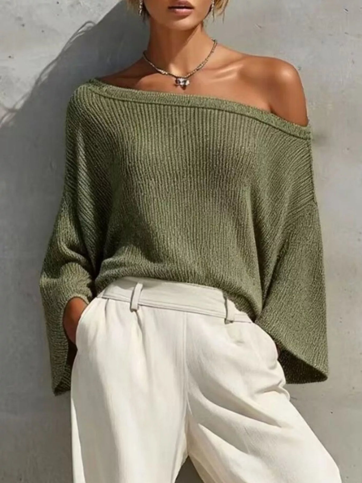 Green one-shoulder knit top and pants set, knit top neckline detail.