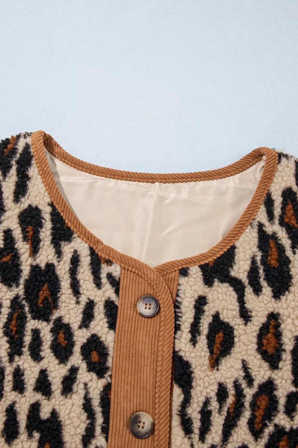 Leopard plush jacket with brown corduroy trim, neckline and lining detail