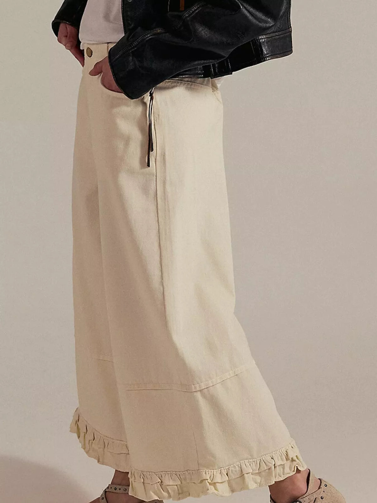 Cream wide-leg ruffle-hem jeans, side view