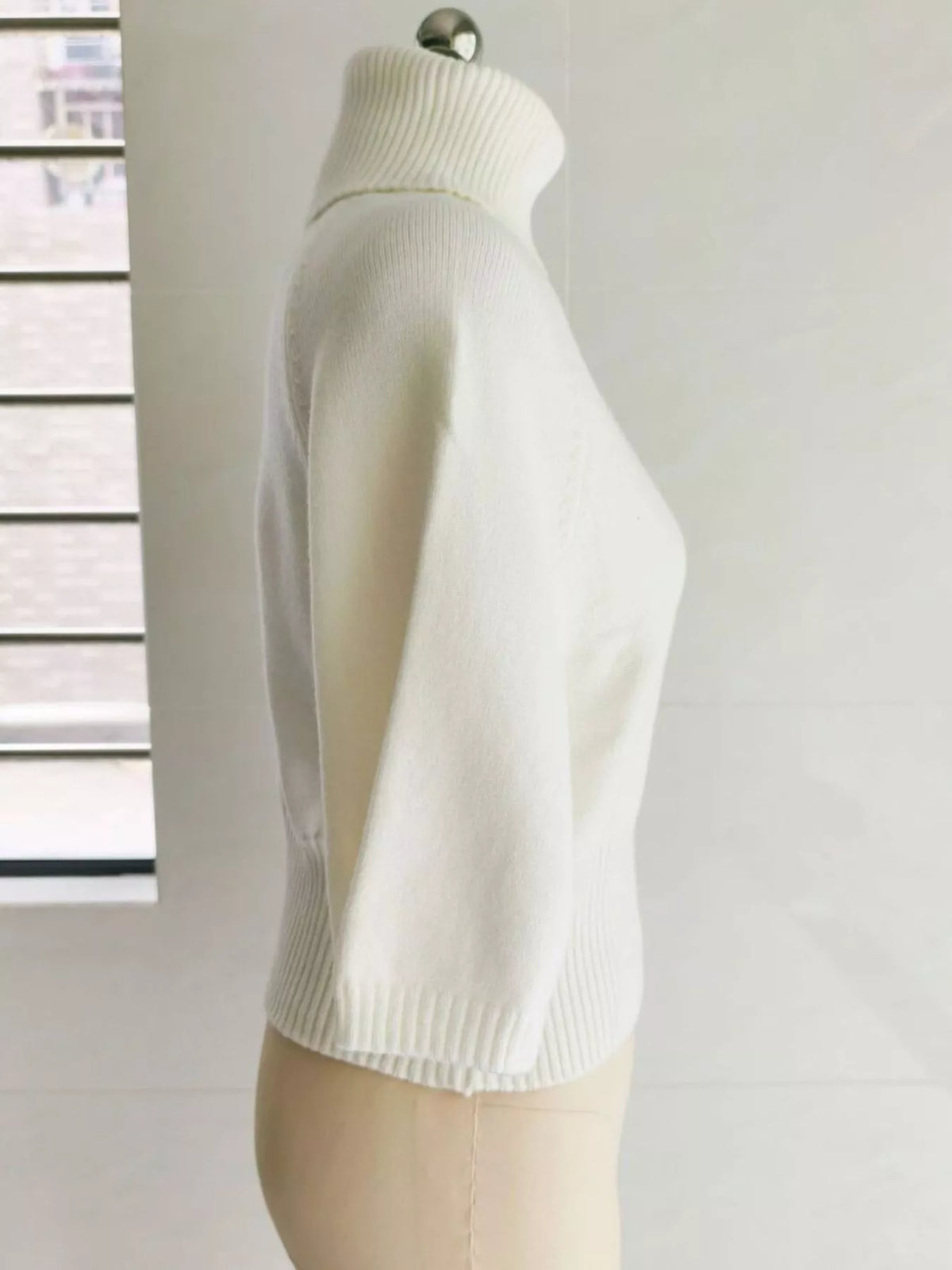 Turtleneck batwing top, cream mannequin side