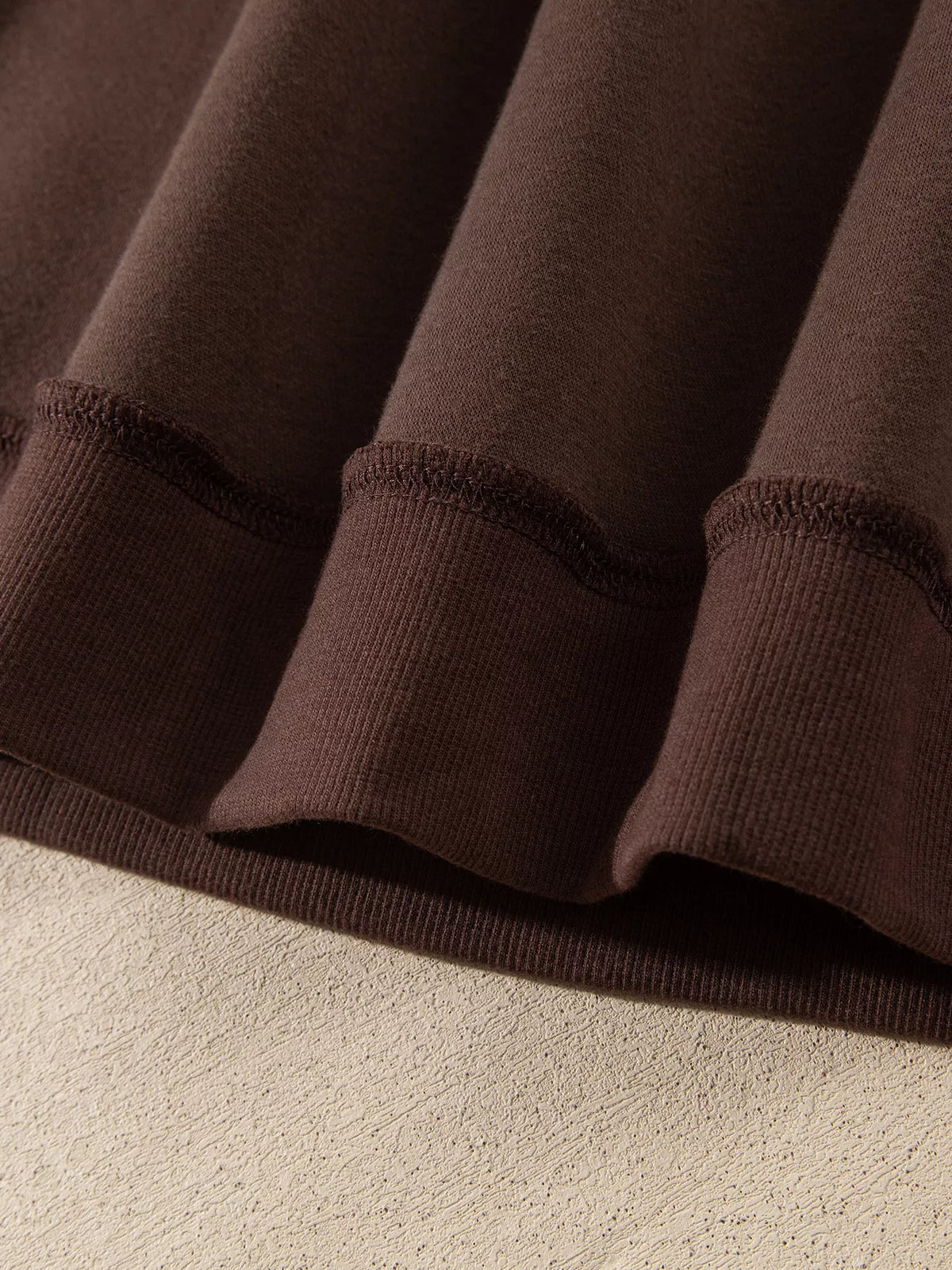 PRAY Polka Dot Embroidered Mock Neck Sweatshirt in dark brown, construction detail