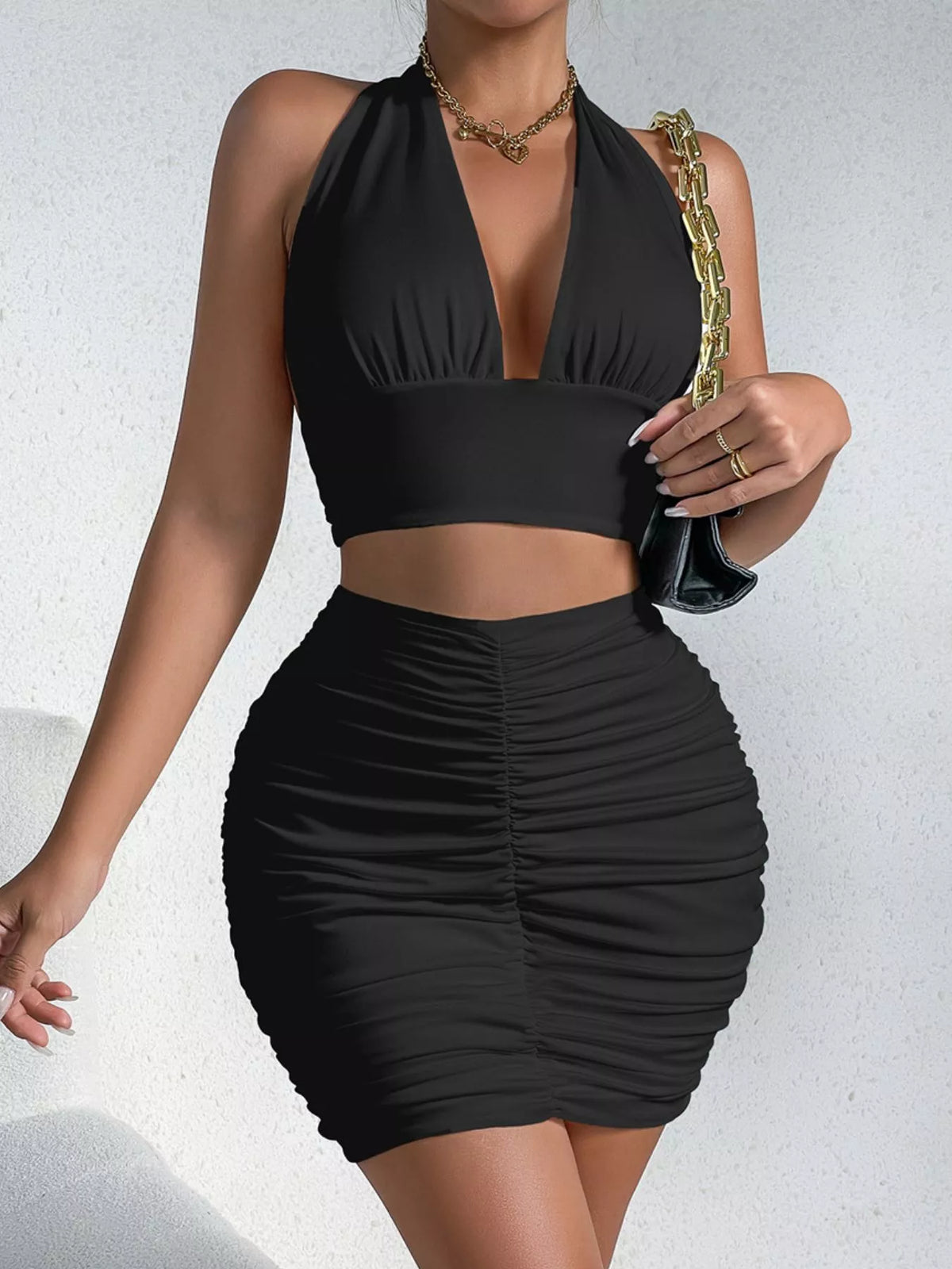Black halter crop top and ruched bodycon mini skirt set
