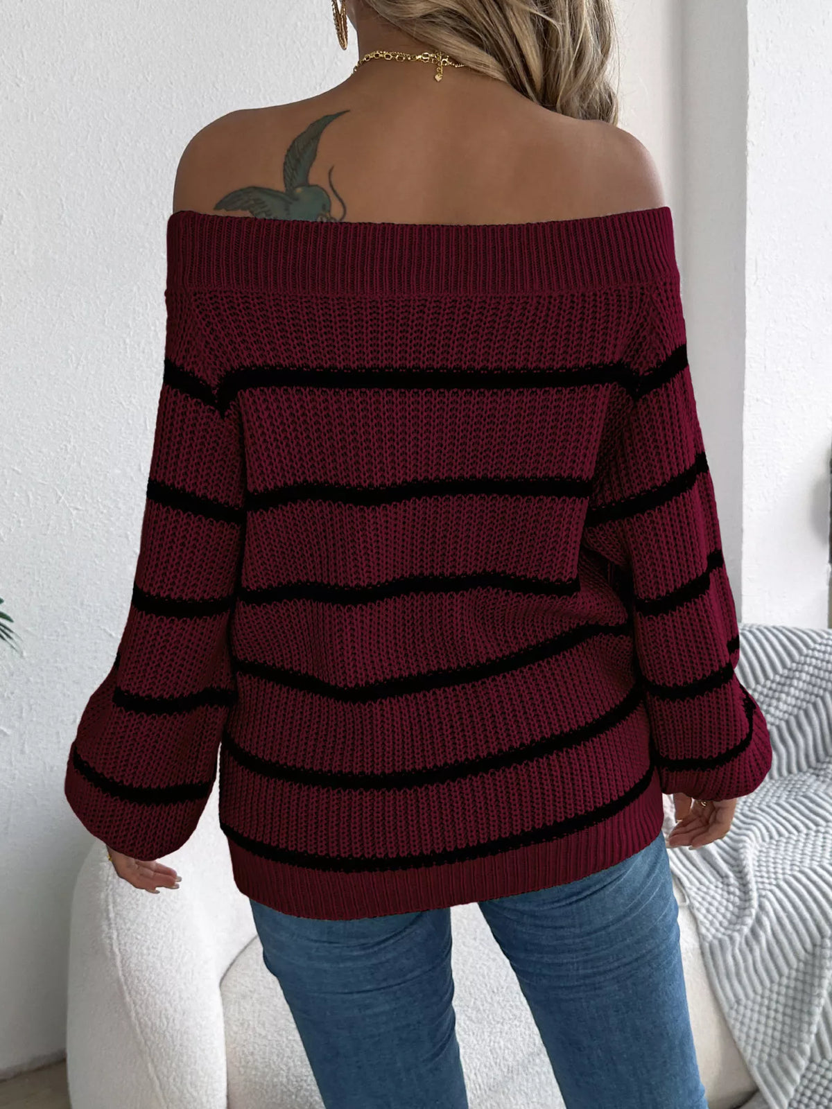 Burgundy off-shoulder striped sweater, back view.