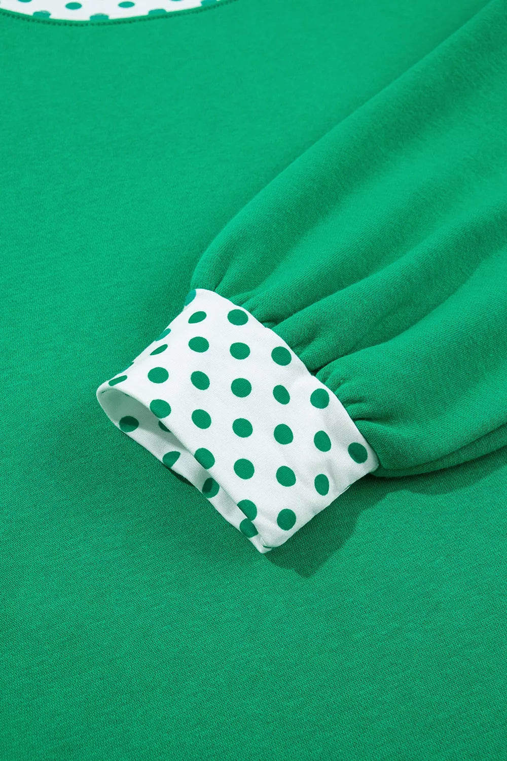 Green sweatshirt and shorts set with polka-dot trim, cuff detail