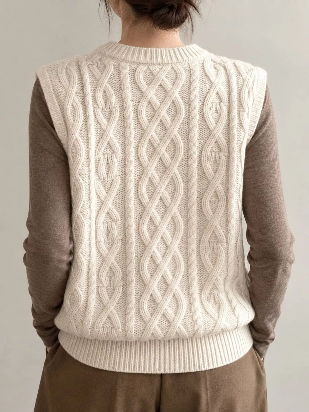 Cream cable-knit sweater vest, back view