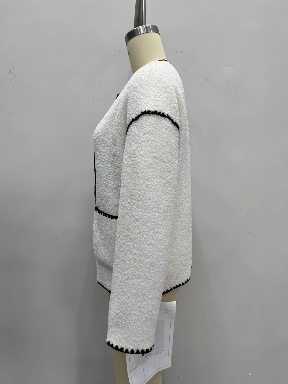 Cream with black trim faux shearling contrast trim button-down jacket, side view