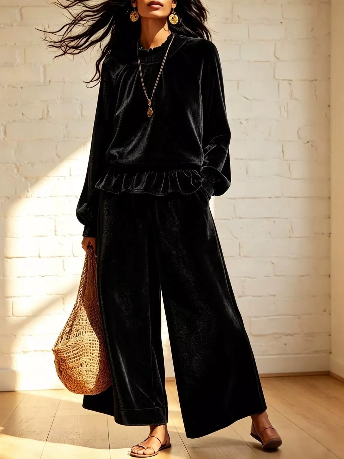Black velvet ruffled hem top and wide-leg pants set — front view