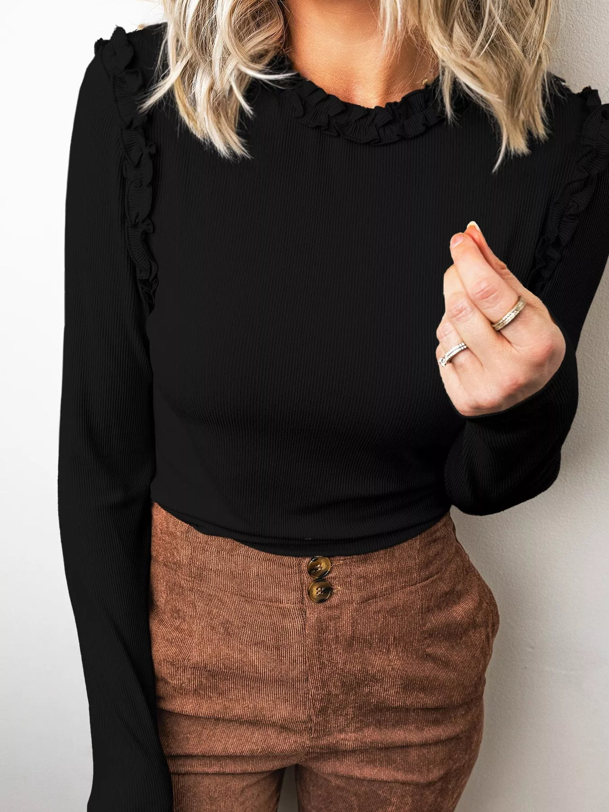 Black round neck frill detail long sleeve top — front view