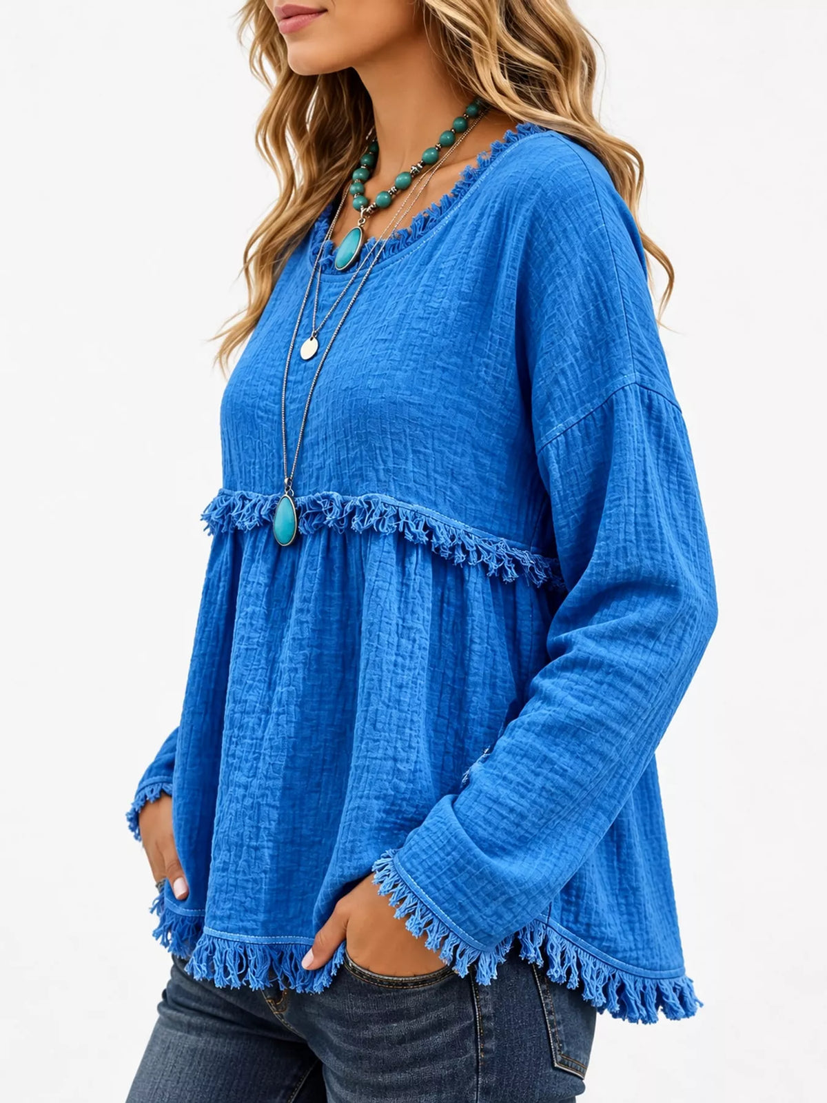 Blue frayed hem textured blouse, side view