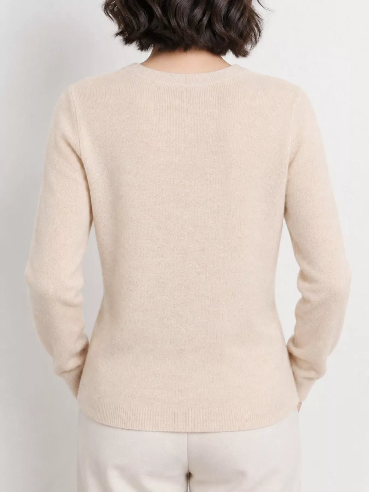 Beige v-neck long sleeve knit top, back view