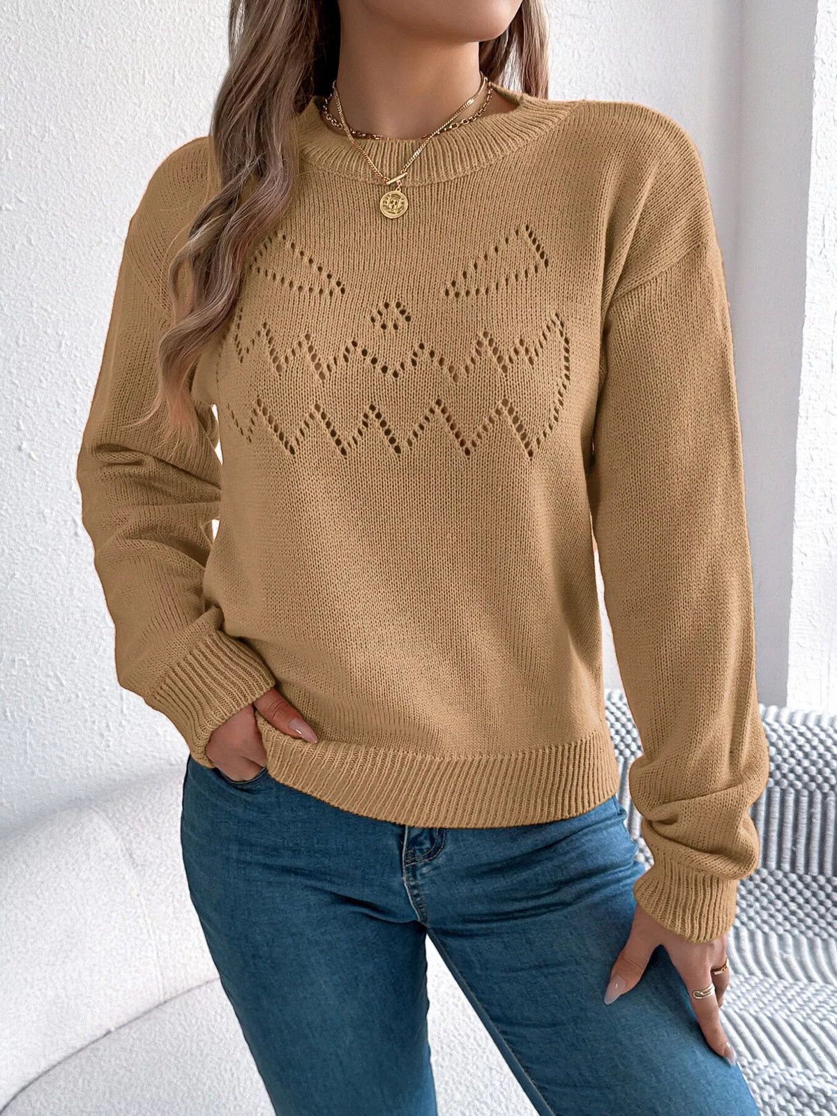 Camel halloween pumpkin face knit sweater, untucked front view.