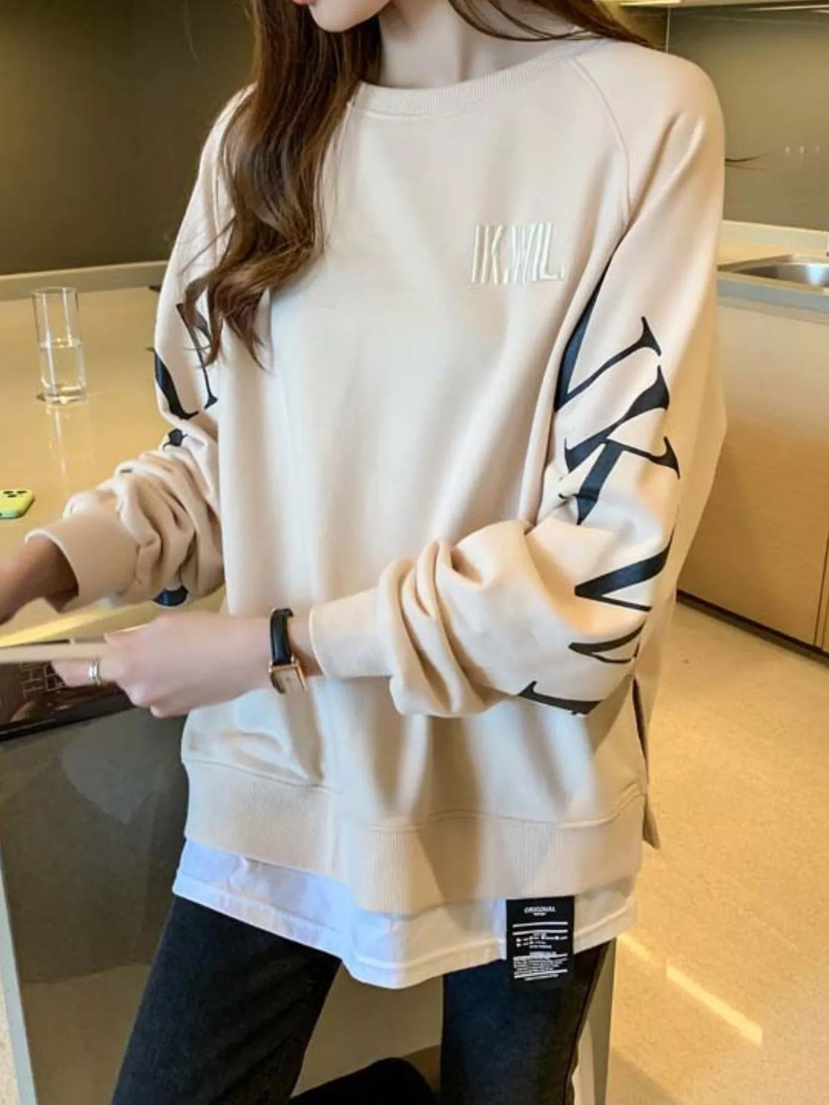 Apricot layered-hem sweatshirt with graphic sleeve detail