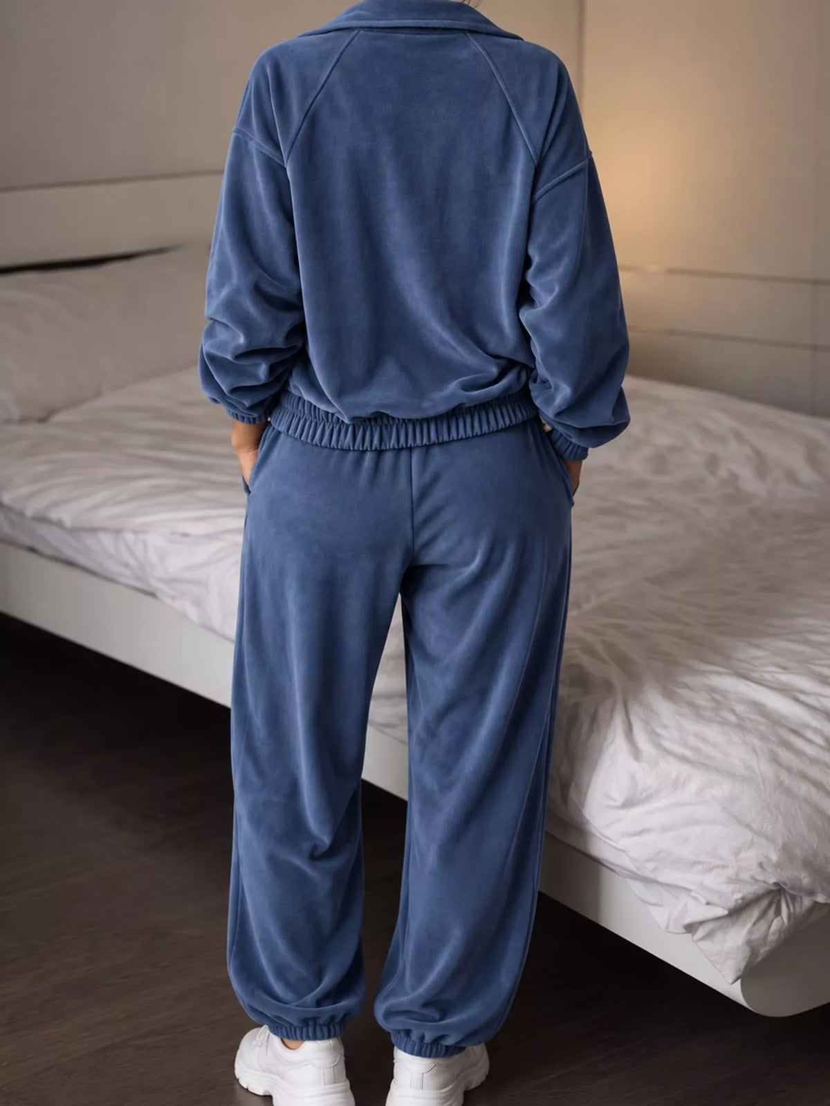 Blue zip-up outerwear and pants set — back view