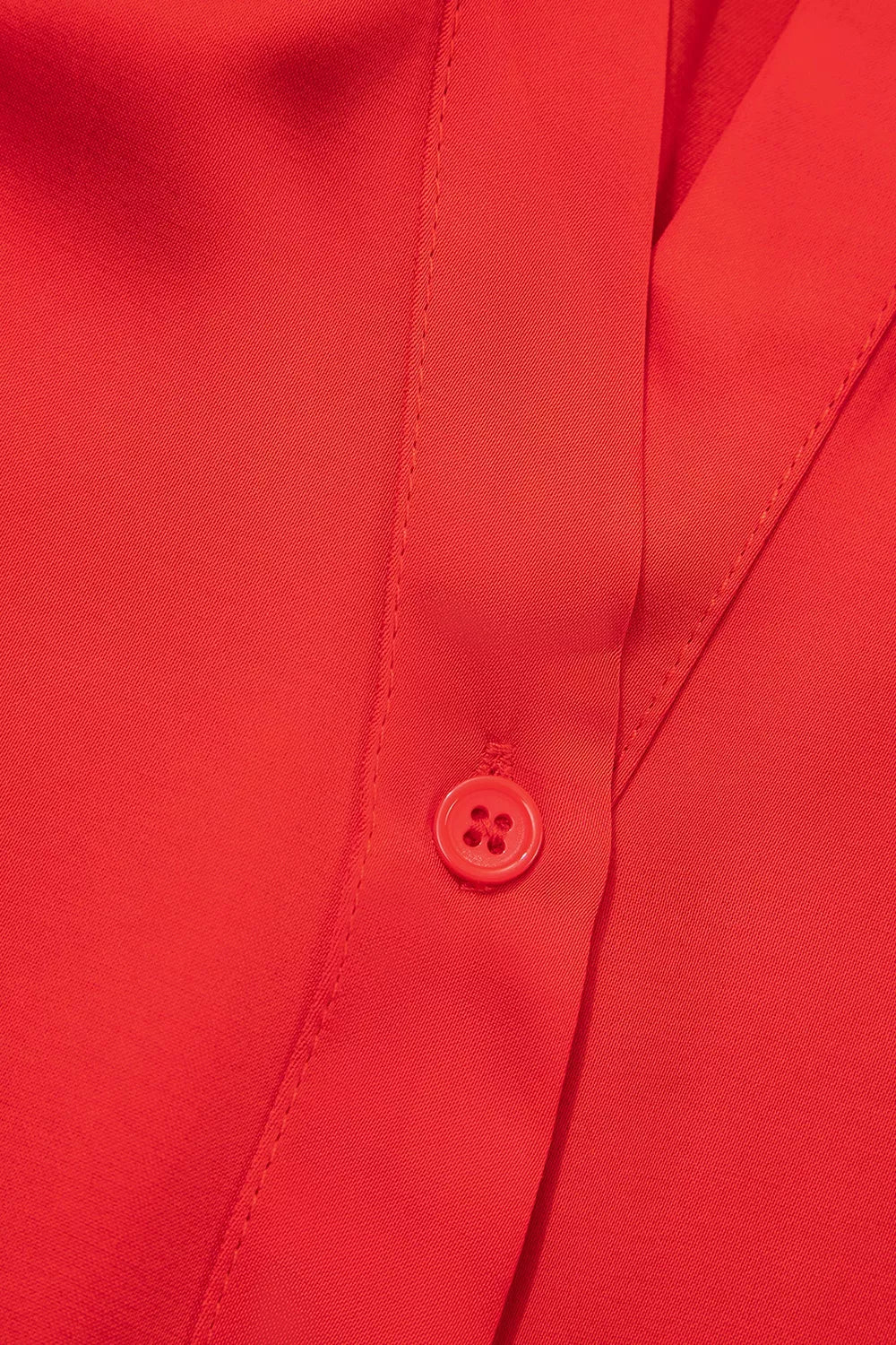 Red lace-panel v-neck button-front shirt, button placket detail.