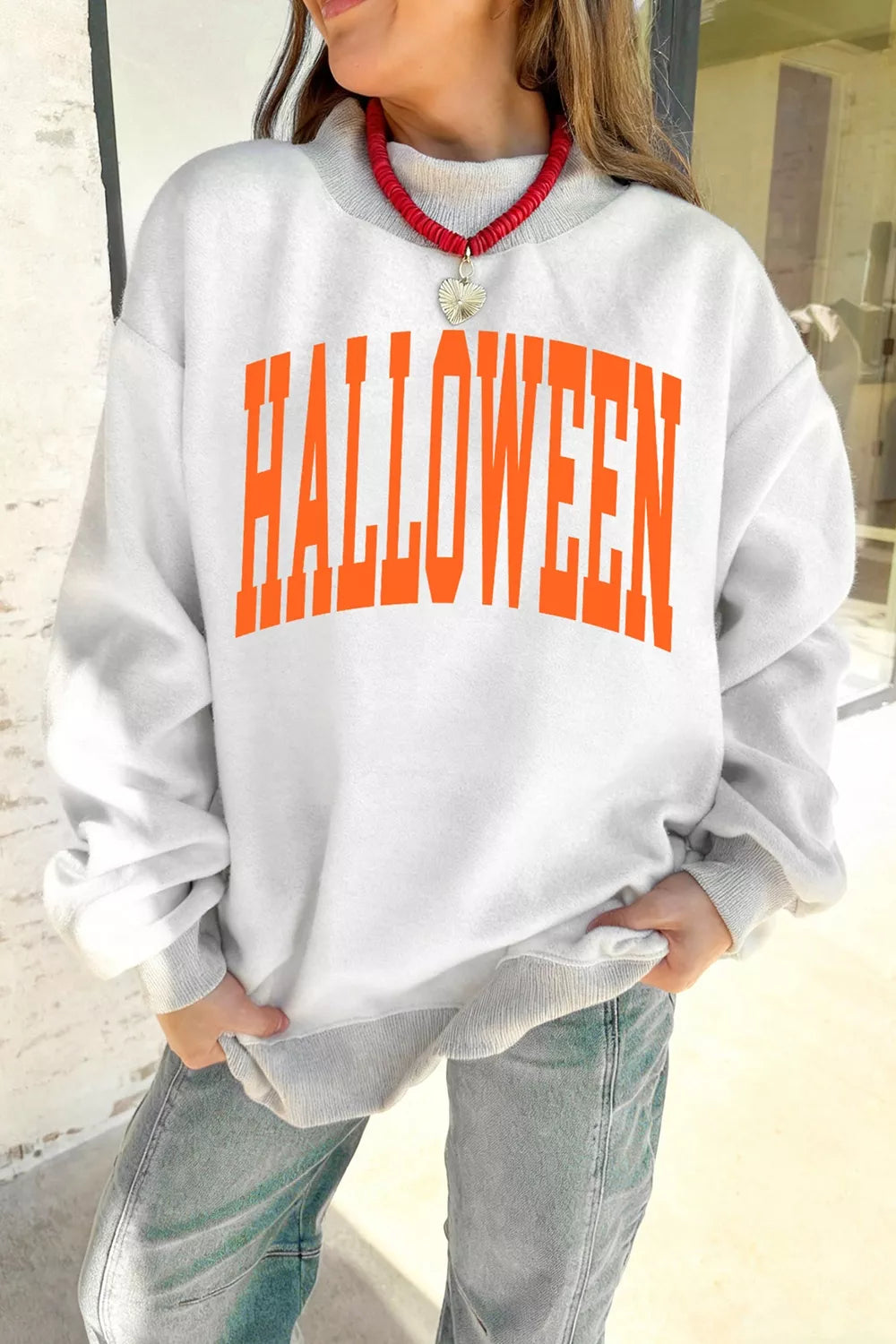 Women's pumpkin face print mock-neck reversible Halloween sweatshirt