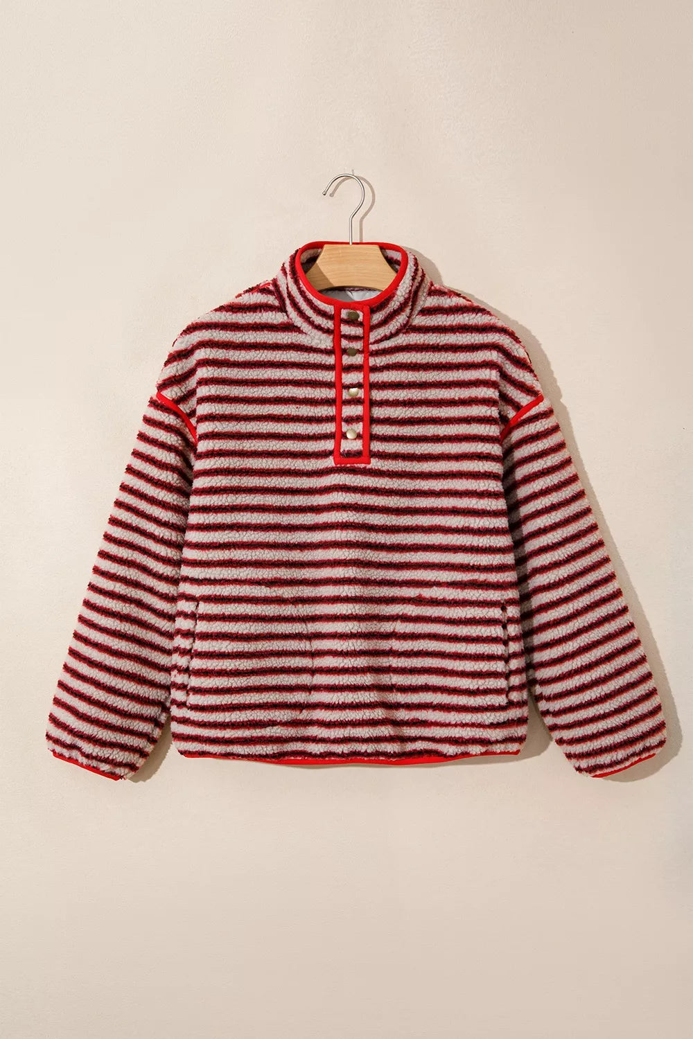 Red and cream striped fuzzy snap-placket sweatshirt, front on hanger
