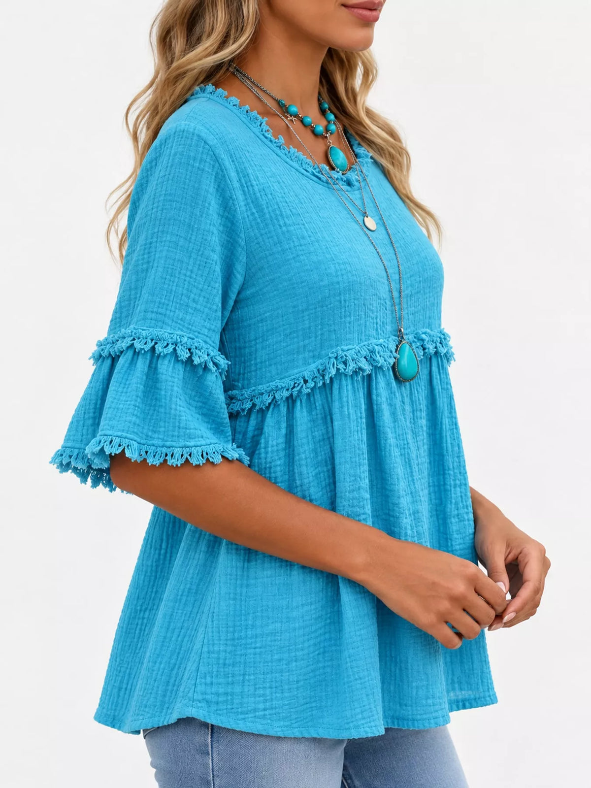 Turquoise frayed edge textured blouse, side view