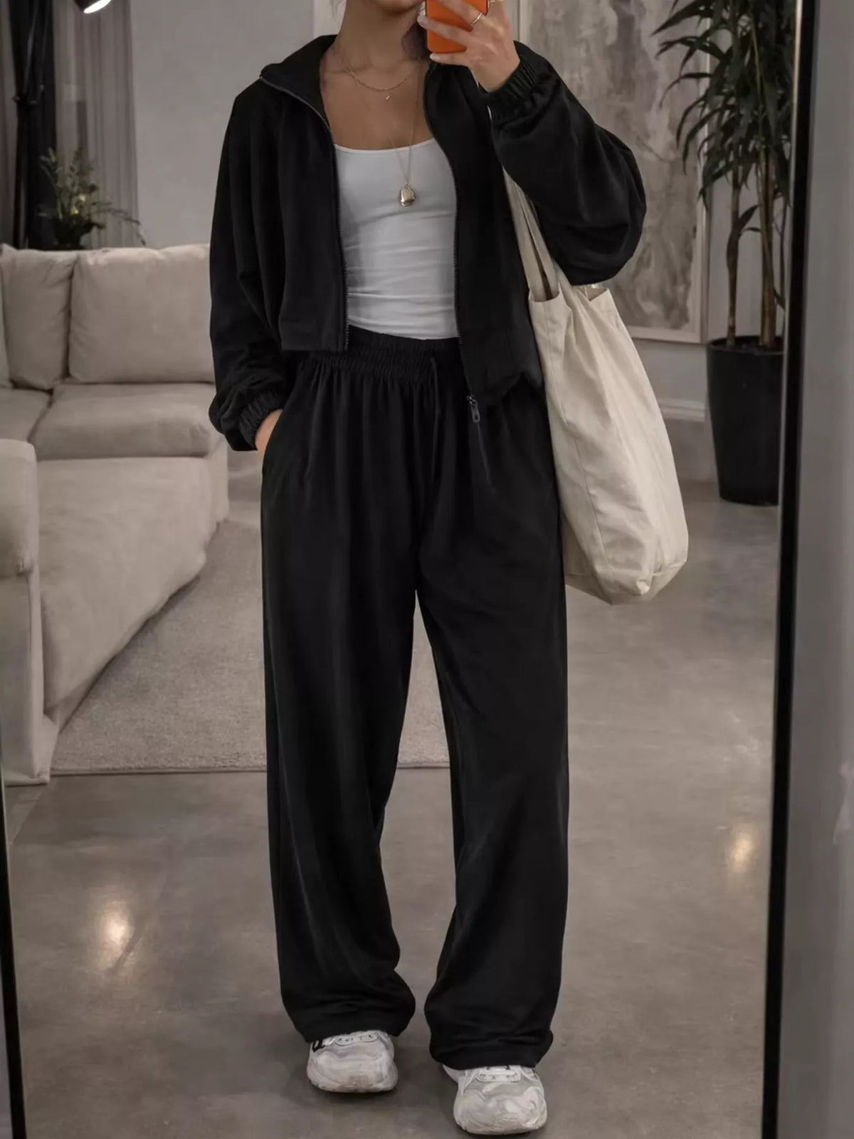 Black zip-up outerwear and pants set — front view