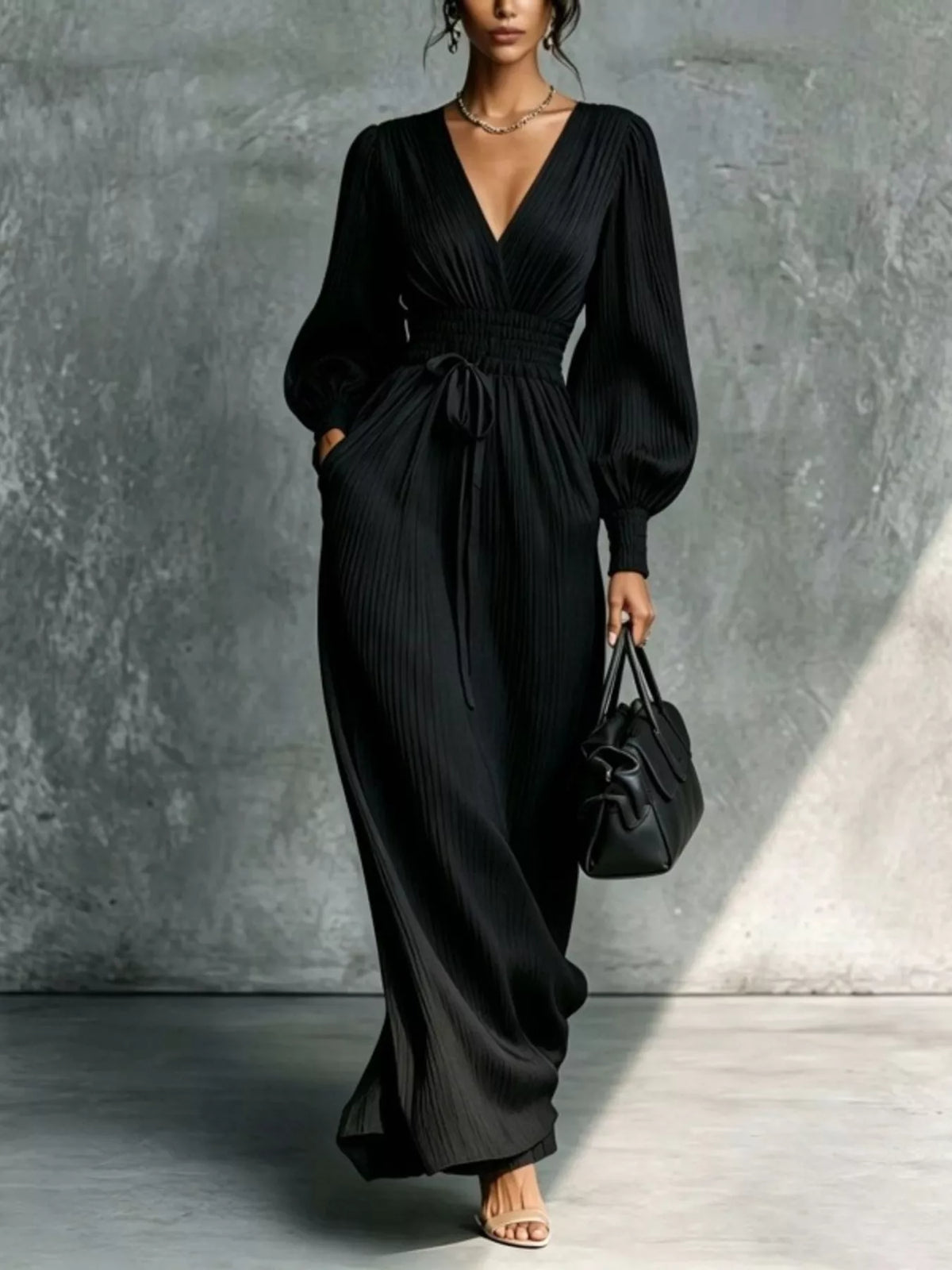 Black pleated v-neck tie-waist maxi dress, full front view.
