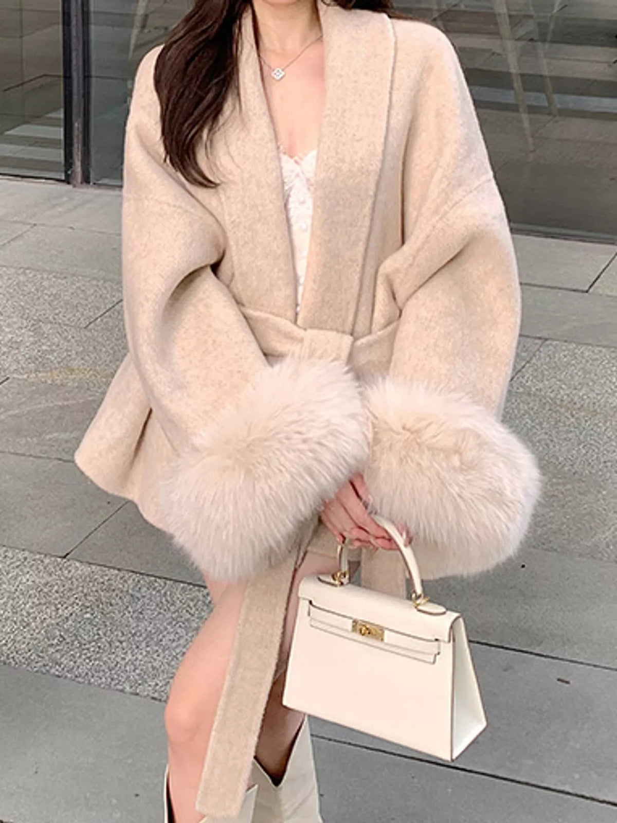 Cream tie-waist coat with faux fur cuffs — front view