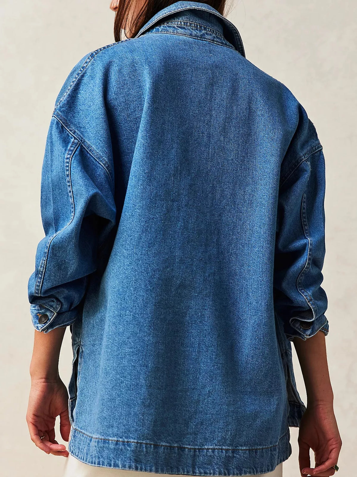 Blue button up long sleeve denim jacket, back view