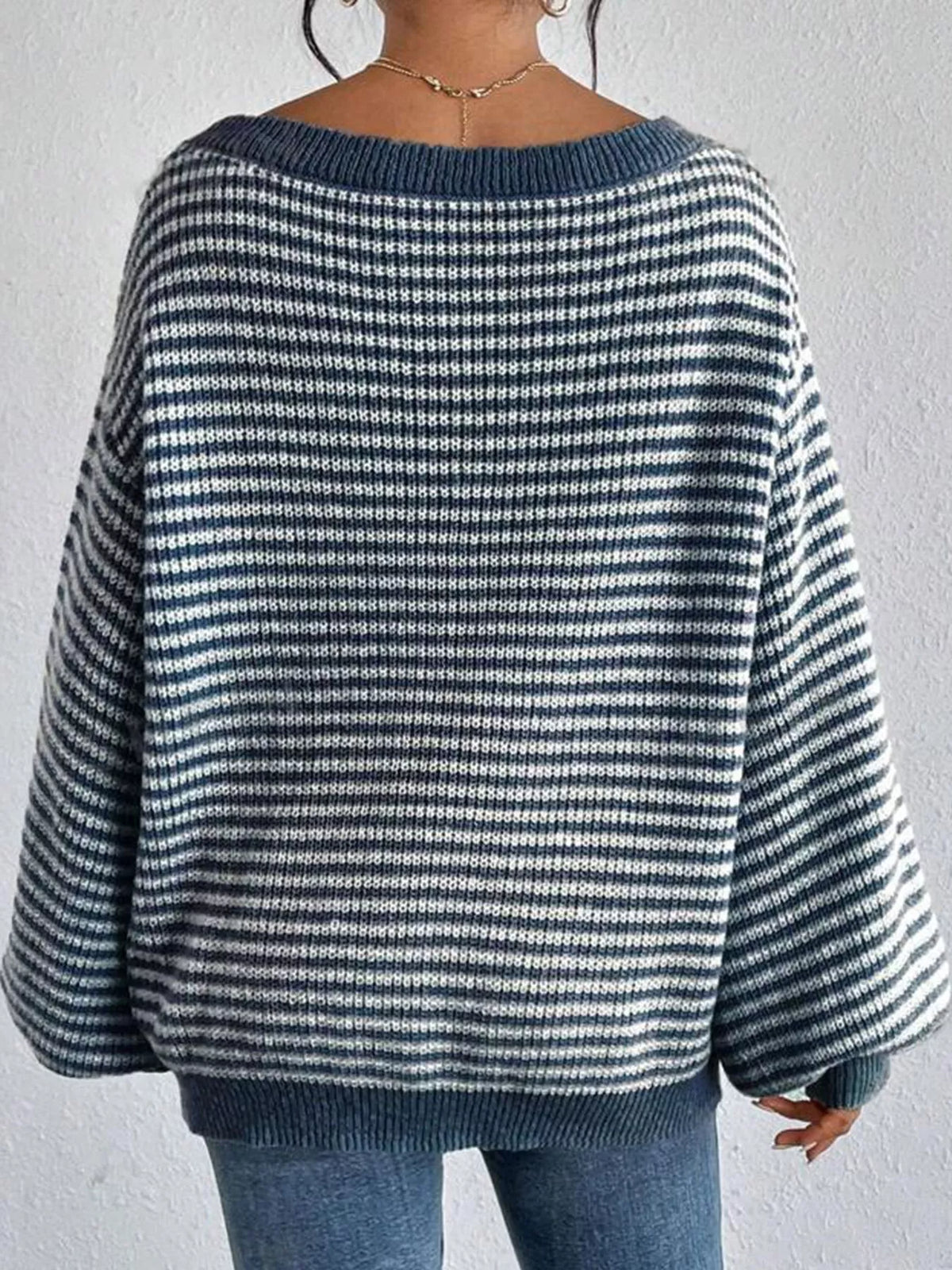 Blue and white striped knit boat neck sweater, back view