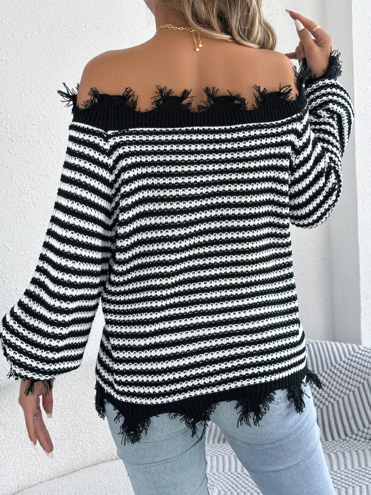 Black off-shoulder frayed hem striped sweater, back view