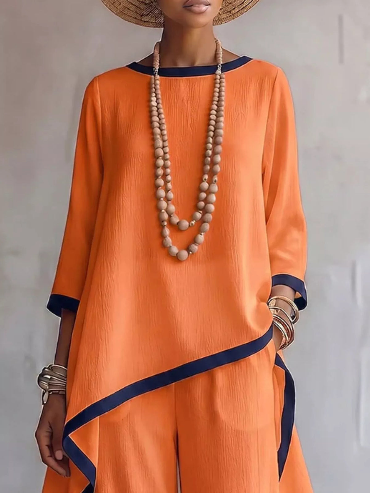 Orange contrast-trim top and pants set, asymmetric top detail