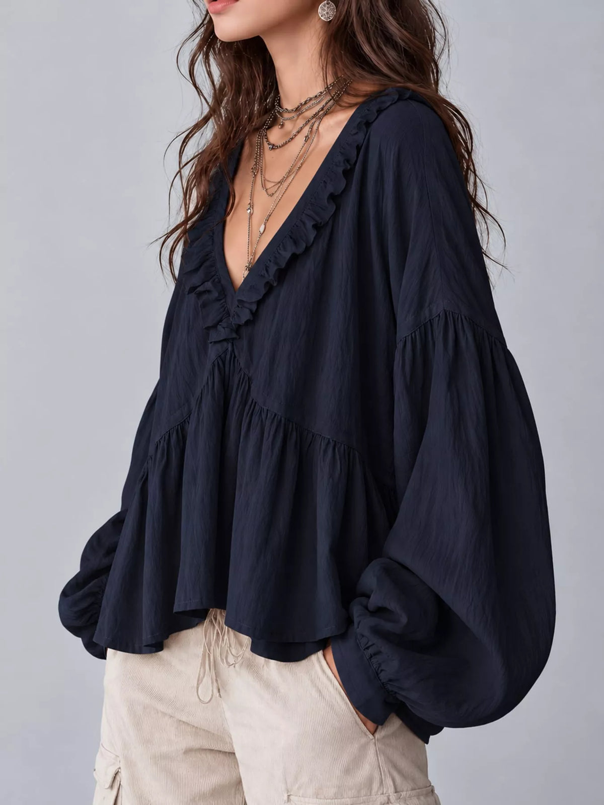 Navy blue ruffled v neck blouse, side view