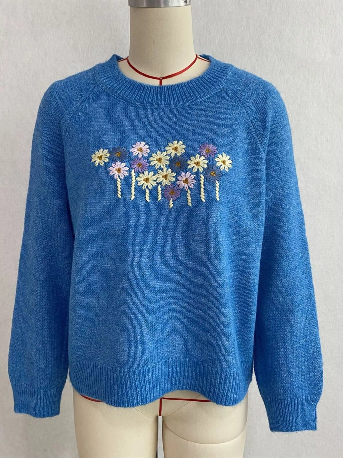 Floral embroidered round-neck sweater in blue, front mannequin view