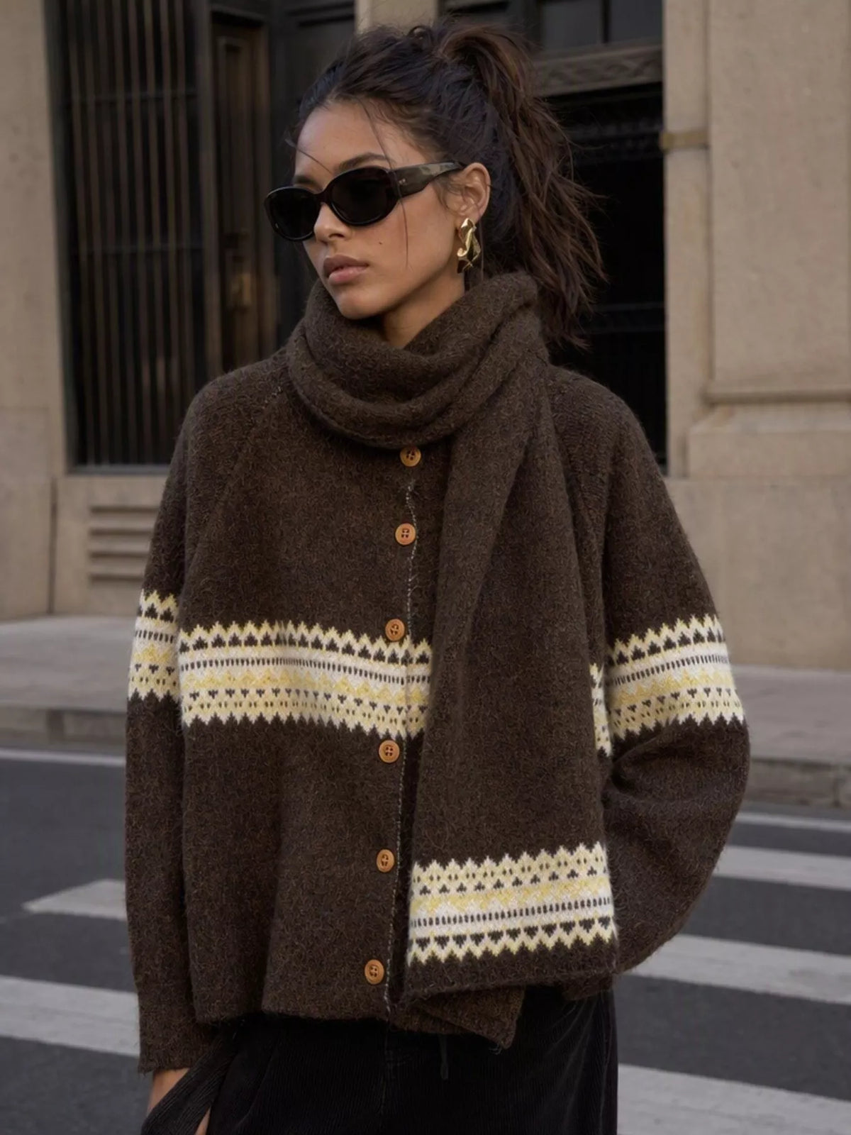 Brown geometric button-front knit cardigan, front view with scarf.