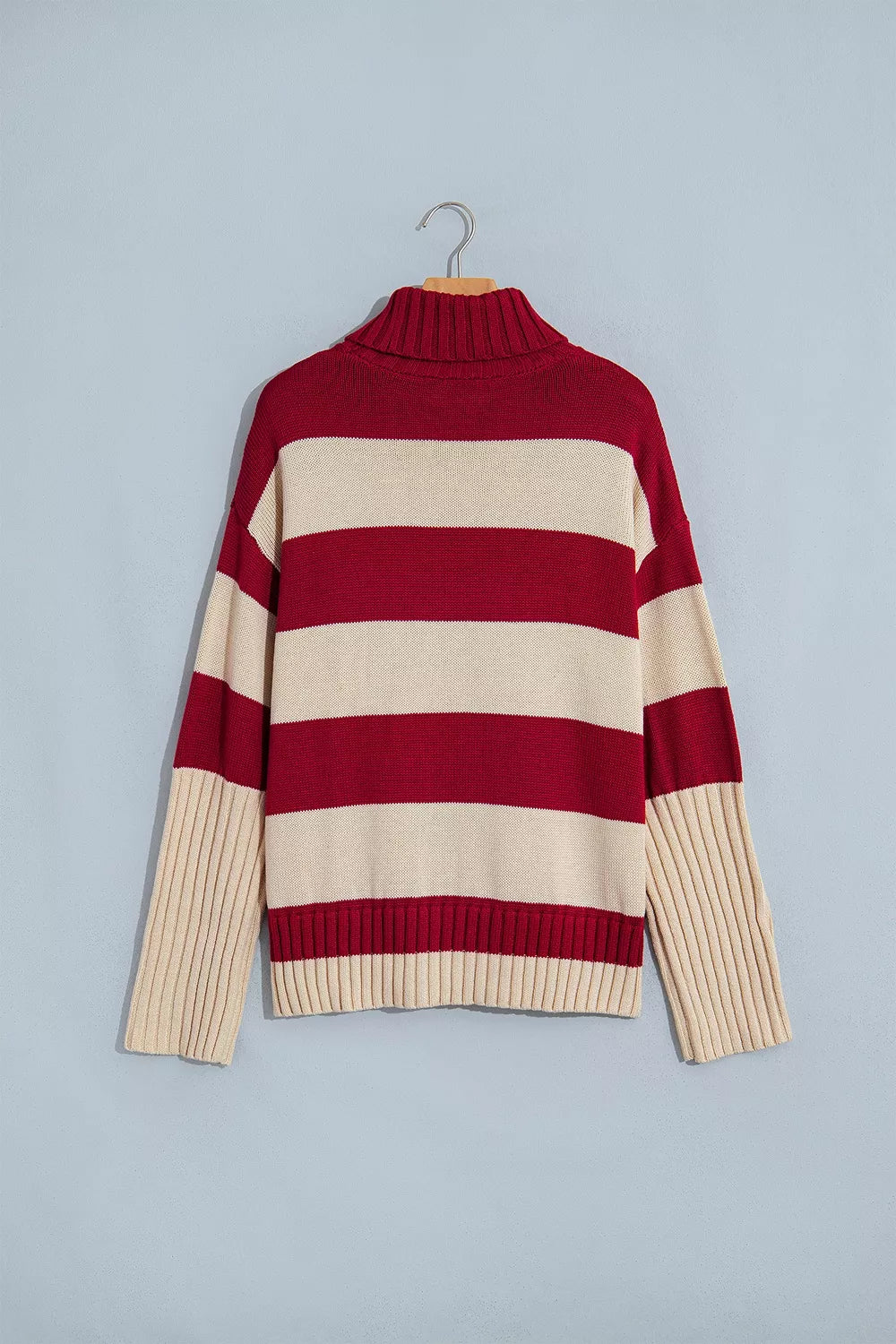 Striped High Neck Ribbed Trim Sweater in red and cream, front on hanger view