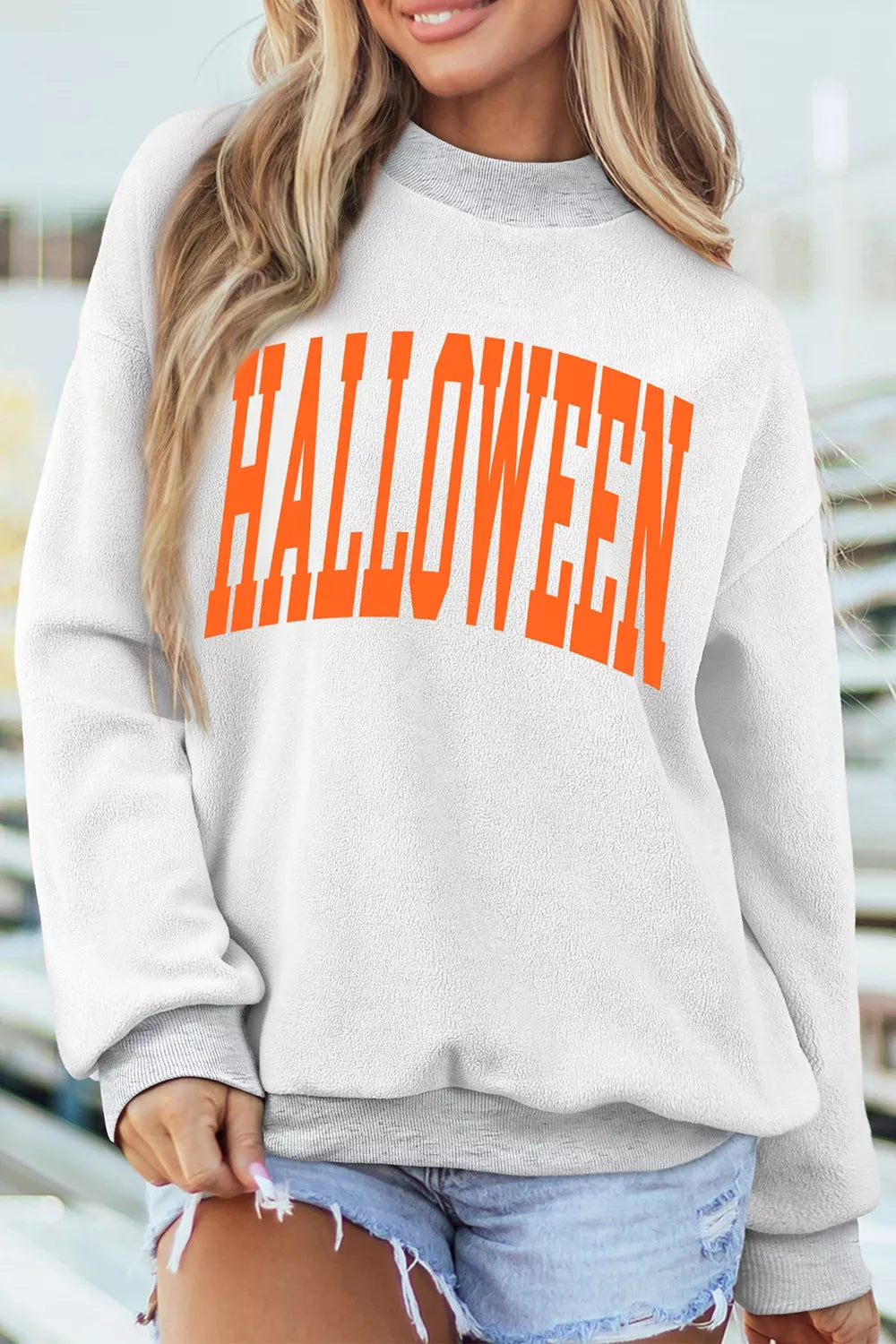 Women's pumpkin face print mock-neck reversible Halloween sweatshirt