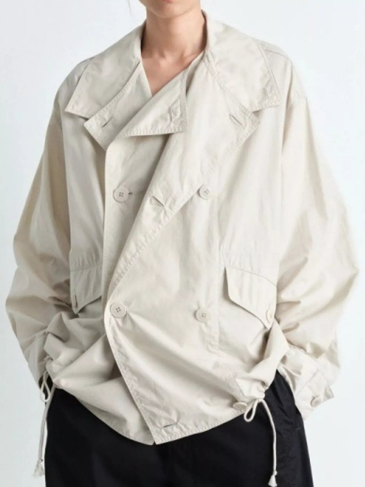 Cream double-breasted utility jacket with drawstring hem — front view