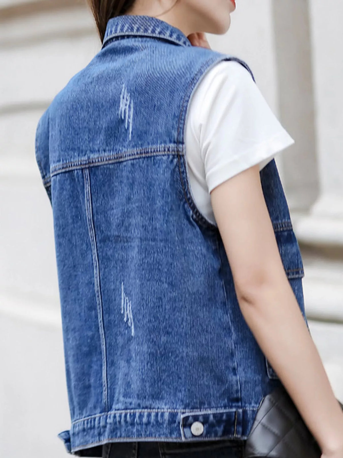 Distressed Washed Denim Vest, back view in blue