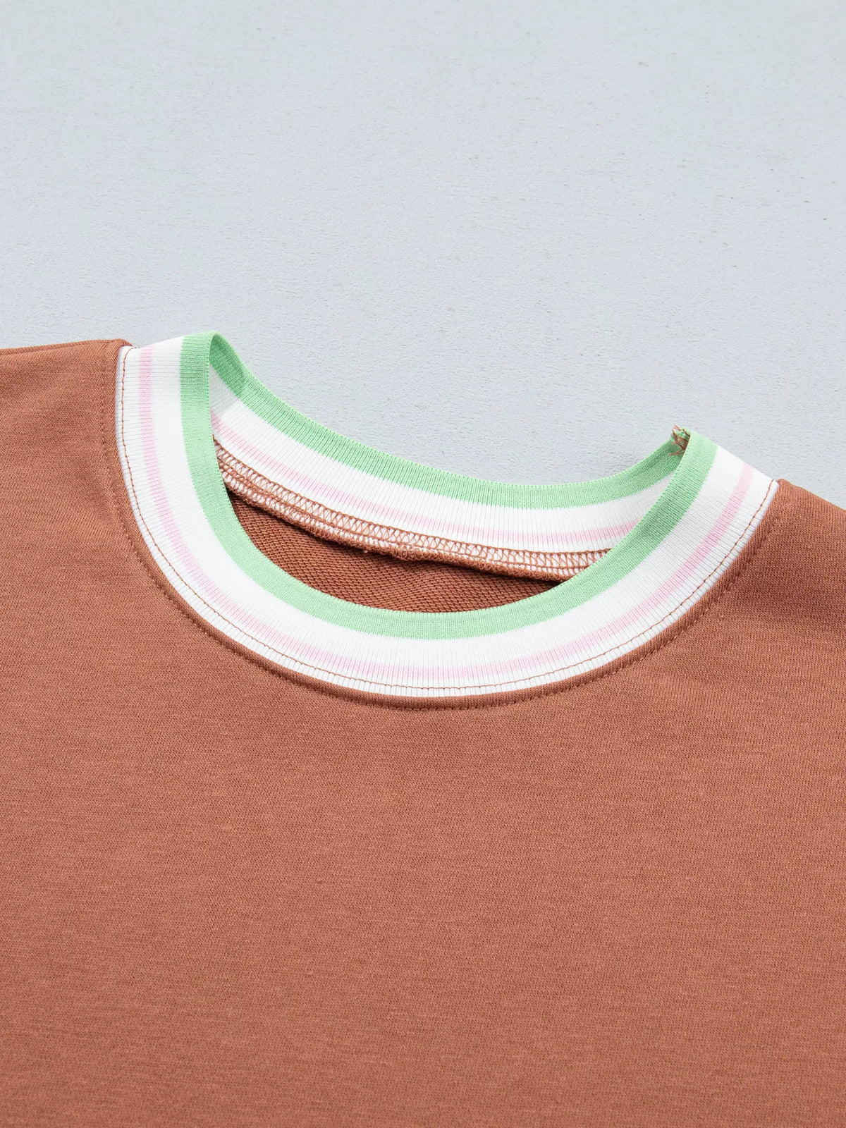 Brown sweatshirt with contrast striped ribbed trim, neckline detail