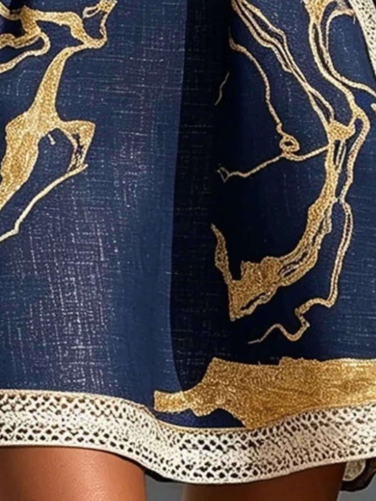 Navy notched 3/4 sleeve mini dress, close-up of the print and hem