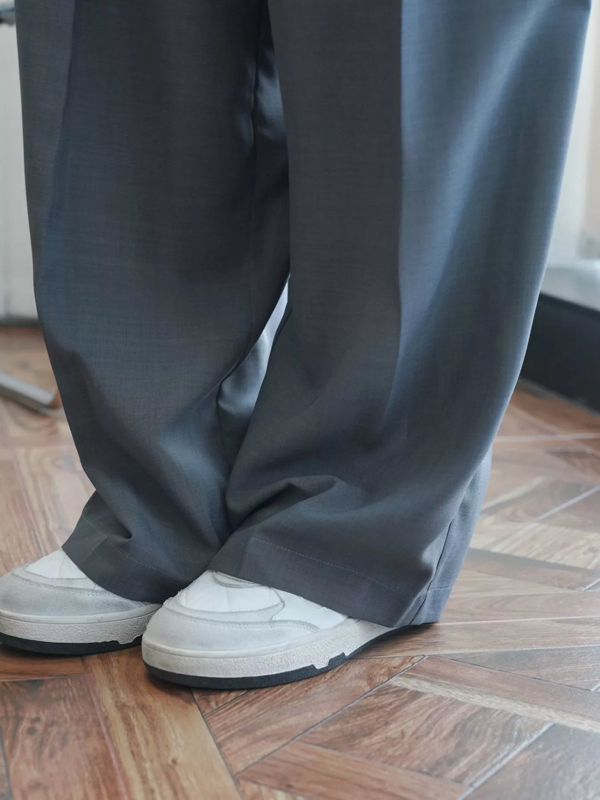 Women's High-Waisted Pleated Wide-Leg Pants in gray — hem detail view