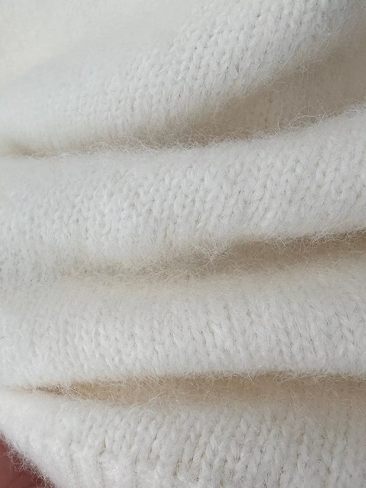 Fuzzy short-sleeve turtleneck sweater in cream, knit texture close-up