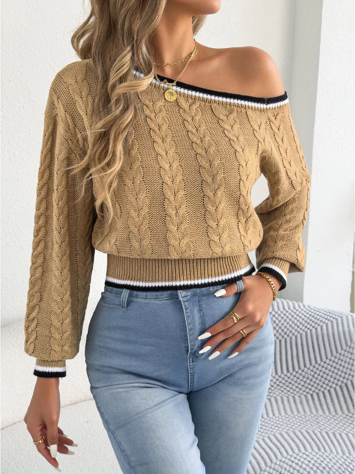 Tan one-shoulder cable knit sweater with striped trim